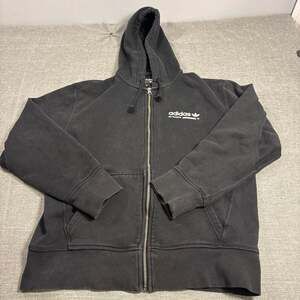 The adidas Originals Kaval Black Full-Zip Hoodie Sweatshirt is a classic piece b